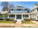 Charming two-story home featuring a welcoming front porch, landscaped yard, and blue siding at 620 Wills Forest St, Raleigh, NC 27605
