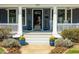 Inviting front porch featuring stylish plants, classic columns, and a well-maintained entrance at 620 Wills Forest St, Raleigh, NC 27605