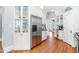 Spacious kitchen with stainless steel refrigerator, white cabinets, and hardwood flooring at 620 Wills Forest St, Raleigh, NC 27605