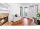 Charming living room with fireplace, built-in seating, and door to outdoor deck at 620 Wills Forest St, Raleigh, NC 27605