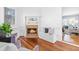 Cozy living room features a brick fireplace, built-in bench, and hardwood floors at 620 Wills Forest St, Raleigh, NC 27605