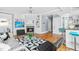 Open living room featuring fireplace, hardwood floors, and view to kitchen at 620 Wills Forest St, Raleigh, NC 27605
