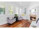 Cozy sitting room with a fireplace, natural light, and hardwood floors at 620 Wills Forest St, Raleigh, NC 27605