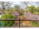 A gorgeous wooded view from a balcony framed by a decorative wood and metal railing at 620 Wills Forest St, Raleigh, NC 27605