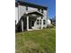 View of a backyard with green grass, landscaping, and a covered patio at 628 Brittany Ct, Durham, NC 27703