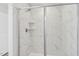 Bathroom shower with marble tiling and frameless glass at 628 Brittany Ct, Durham, NC 27703