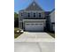 A charming gray two-story home with a large driveway and attached two-car garage at 628 Brittany Ct, Durham, NC 27703