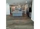 Open-concept kitchen features a gray island, stainless steel appliances, and modern pendant lighting at 628 Brittany Ct, Durham, NC 27703