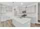 Modern kitchen features sleek white countertops, stainless steel appliances, and a spacious central island at 628 Brittany Ct, Durham, NC 27703