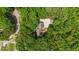 A serene aerial view of the house is nestled among lush greenery, providing a private and tranquil setting at 63 Tally Ho Dr, Selma, NC 27576