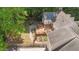 Aerial view of a backyard featuring a wooden deck, garden, stone pathway, grilling area, and lush green trees at 63 Tally Ho Dr, Selma, NC 27576