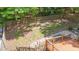 The spacious backyard features a wood fence, mature trees and a large grassy area for outdoor recreation at 63 Tally Ho Dr, Selma, NC 27576