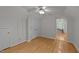 Hardwood bedroom featuring storage, a ceiling fan, and a doorway into an adjacent room at 63 Tally Ho Dr, Selma, NC 27576