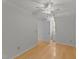 Bedroom featuring hardwood floors, a ceiling fan, and natural light from a large window at 63 Tally Ho Dr, Selma, NC 27576