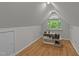Bonus room with hardwood floors, natural light, and a built-in shelving unit at 63 Tally Ho Dr, Selma, NC 27576