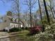 Exterior view of home featuring dormer windows, siding, and a surrounding landscape with trees and shrubs at 63 Tally Ho Dr, Selma, NC 27576