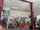 Spacious garage with a vehicle lift, tool storage, and ample space for automotive projects at 63 Tally Ho Dr, Selma, NC 27576
