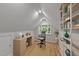 Bright home office with hardwood floors, a large window, and a decorative bookcase at 63 Tally Ho Dr, Selma, NC 27576