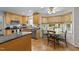 Bright kitchen with wooden cabinets, stainless steel appliances, a breakfast nook with a view, and tile flooring at 63 Tally Ho Dr, Selma, NC 27576