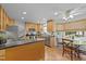 Well-lit kitchen with wooden cabinets, stainless steel appliances, tile flooring, and a cozy breakfast nook at 63 Tally Ho Dr, Selma, NC 27576