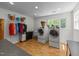 Bright laundry room with modern washer and dryer units, ample storage, and large windows at 63 Tally Ho Dr, Selma, NC 27576