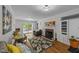 Cozy living room featuring a brick fireplace, hardwood floors, and a sliding glass door leading to the patio at 63 Tally Ho Dr, Selma, NC 27576