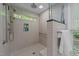 Shower features tiled walls, a window, and mounted shower head at 63 Tally Ho Dr, Selma, NC 27576