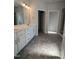 Bright bathroom with double sinks, white cabinets, and a large mirror with modern lighting at 644 Sweet Potato Lane # 36, Nashville, NC 27856