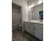 Bathroom features dual sinks, white cabinets, and a shower and bathtub combo behind the door at 644 Sweet Potato Lane # 36, Nashville, NC 27856