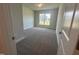 Inviting bedroom with plush carpet, neutral walls, and ample natural light streaming through the window at 644 Sweet Potato Lane # 36, Nashville, NC 27856