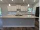 Close-up of the kitchen island with granite countertops and white cabinets with modern faucet at 644 Sweet Potato Lane # 36, Nashville, NC 27856