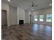 Living room featuring fireplace, wood flooring and lots of natural light at 644 Sweet Potato Lane # 36, Nashville, NC 27856