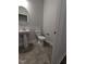 Powder room featuring modern fixtures, pedestal sink, and neutral colored tile floor at 644 Sweet Potato Lane # 36, Nashville, NC 27856