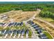 Aerial view of a new neighborhood development near wooded area with a pond at 653 Corvair Ln, Wendell, NC 27591