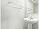 Bathroom featuring pedestal sink, mirror, towel bar, and white paint at 653 Corvair Ln, Wendell, NC 27591