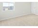 Neutral-toned bedroom with carpet and a large window offering neighborhood views at 653 Corvair Ln, Wendell, NC 27591