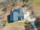 Aerial view of the home, roof, driveway and yard surrounded by trees at 7950 Country Knoll Rd, Bahama, NC 27503