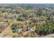 Overhead aerial of home nestled within a vibrant community filled with trees at 7950 Country Knoll Rd, Bahama, NC 27503