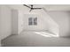 Attic bedroom features ceiling fan, window, neutral walls and carpet at 7950 Country Knoll Rd, Bahama, NC 27503