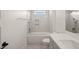 Bright bathroom with a modern bathtub, shower, white tiles, and a toilet at 7950 Country Knoll Rd, Bahama, NC 27503