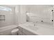 Modern bathroom featuring white subway tiles, a shower and bathtub, with a gray vanity at 7950 Country Knoll Rd, Bahama, NC 27503