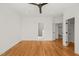 Large bedroom with hardwood floors, neutral walls and trim, adjoining bathroom and walk in closet at 7950 Country Knoll Rd, Bahama, NC 27503