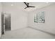 White bedroom features closet, ceiling fan, neutral carpet, and window at 7950 Country Knoll Rd, Bahama, NC 27503