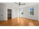 Bedroom with hardwood floors, neutral walls and trim, windows letting in natural light, walk in closet at 7950 Country Knoll Rd, Bahama, NC 27503