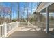 Elevated wooden deck with white railings and screens, with backyard view at 7950 Country Knoll Rd, Bahama, NC 27503