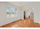 Bright dining room with hardwood floors, modern light fixture, and large windows at 7950 Country Knoll Rd, Bahama, NC 27503