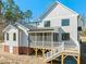 Back view of home showcasing back porch, a wooden deck and siding at 7950 Country Knoll Rd, Bahama, NC 27503
