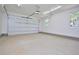 Spacious garage with a roll-up door, ample lighting and windows at 7950 Country Knoll Rd, Bahama, NC 27503