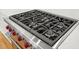 Close up of the cooktop with six burners and stainless steel trim at 7950 Country Knoll Rd, Bahama, NC 27503