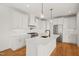 Bright kitchen with white cabinets, quartz countertops, and stainless steel appliances at 7950 Country Knoll Rd, Bahama, NC 27503